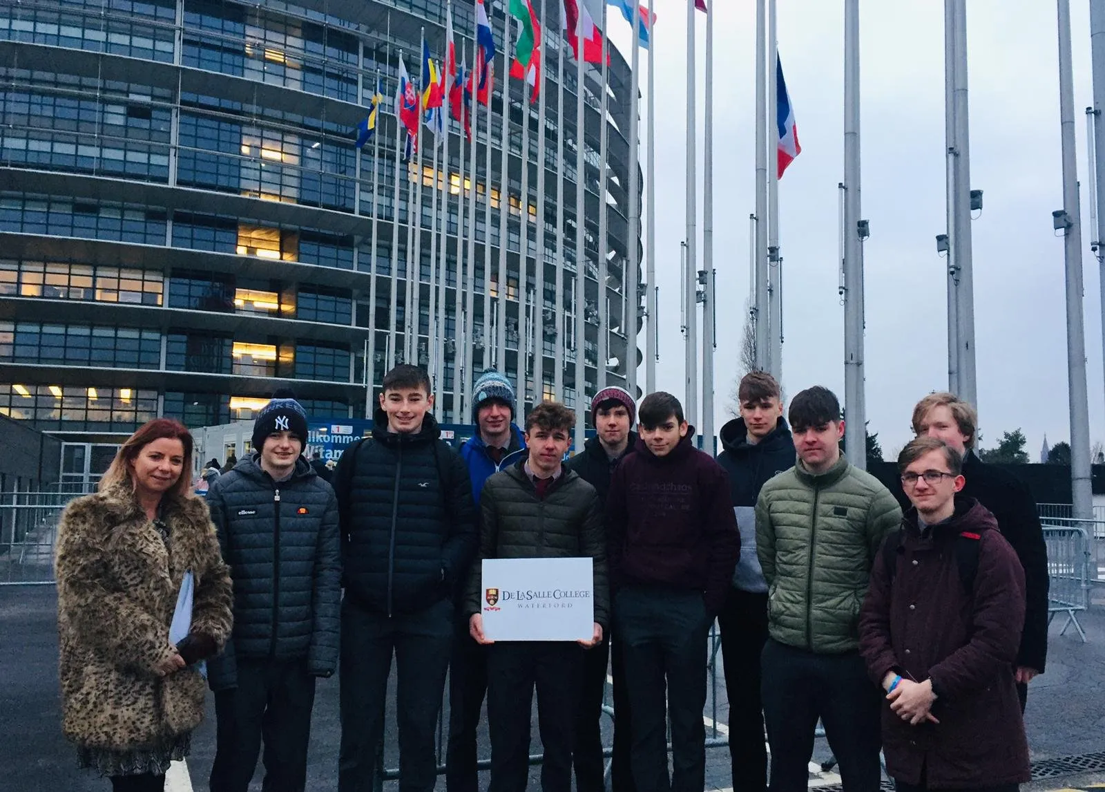De La Salle students standing outside an EU institution building with flags flying